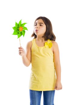 Beautiful girl blowing a plastic windmill