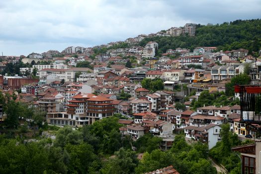 European houses with brown tile roof on the hills and mountains. Veloko Tarnovo