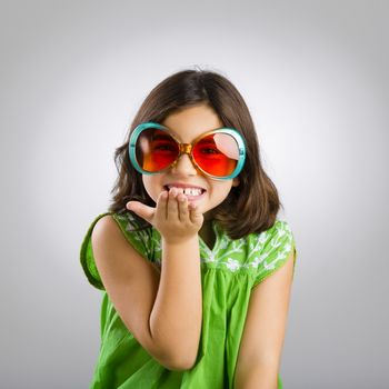 Portrait of a happy young girl wearing funny sunglasses