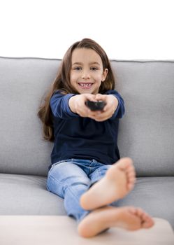 Little girl holding a TV remote control