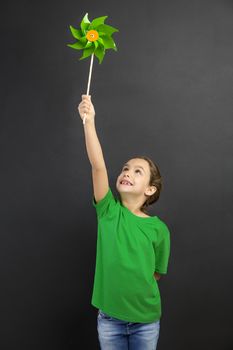 Beautiful little girl smilling and holding a windmill