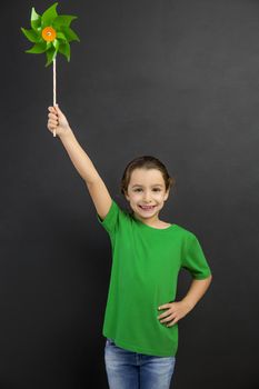 Beautiful little girl smilling and holding a windmill