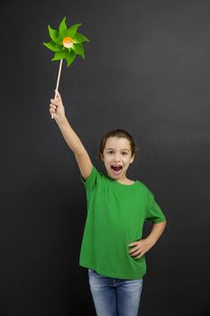 Beautiful little girl smilling and holding a windmill