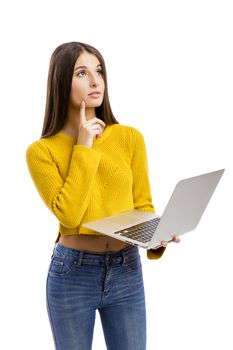 Beautiful and happy girl working with a laptop, isolated over white background 