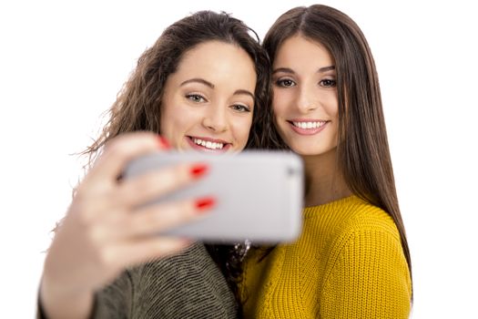 Teen girls with smartphone taking selfie