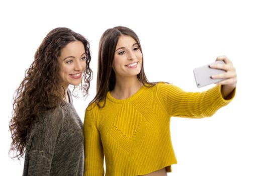 Teen girls with smartphone taking selfie