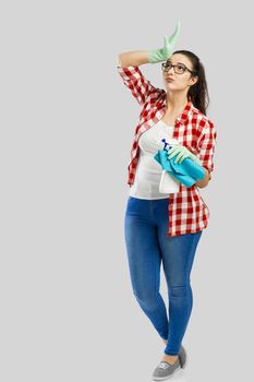 Woman portrait tired of cleaning, isolated over a gray background