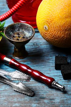Still life with slices of ripe melon and smoking hookah
