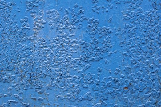 fragment of an iron surface is covered with blue color paint, which has long been under the influence of different climatic conditions