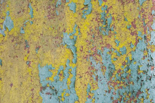 fragment of an iron surface is covered with paint, which has long been under the influence of different climatic conditions