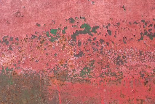 fragment of an iron surface is covered with pink color paint, which has long been under the influence of different climatic conditions