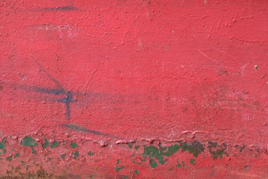 fragment of an iron surface is covered with red color paint, which has long been under the influence of different climatic conditions