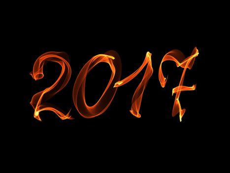 Happy new year 2017 isolated numbers written with flame light on black background.