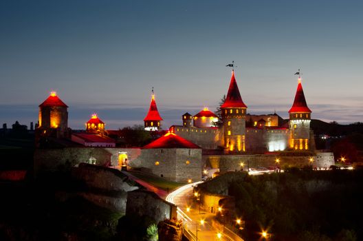 Old Castle Kamenetz-Podolsk - medieval castle, one of the historical monuments of Ukraine. View of a beautiful castle at night.