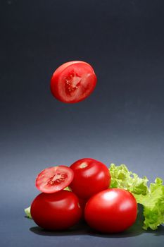 Cooking concept. Few freshness red tomatoes on dark background