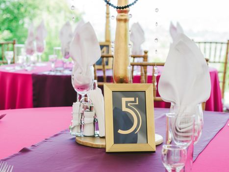 Wedding table with sign number five. Guests wedding table with sign of number 5