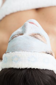 Woman receiving a facial mask treatment