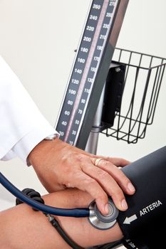 Doctor measuring blood pressure to a patient