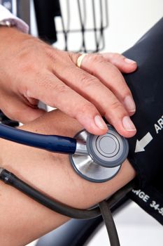 Doctor measuring blood pressure to a patient