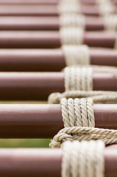 Close up of rope tied knot around metal pipe