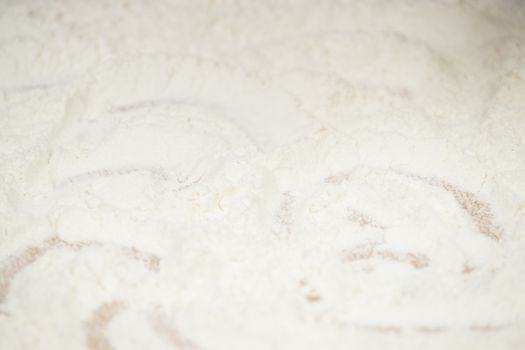 Women's hands preparing flour before baking pie.