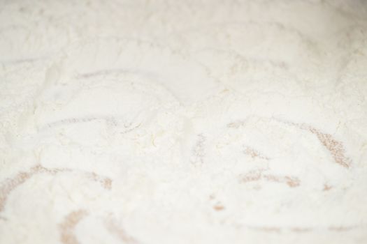 Women's hands preparing flour before baking pie.