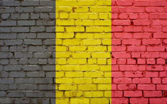 Flag of Belgium painted on brick wall, background texture