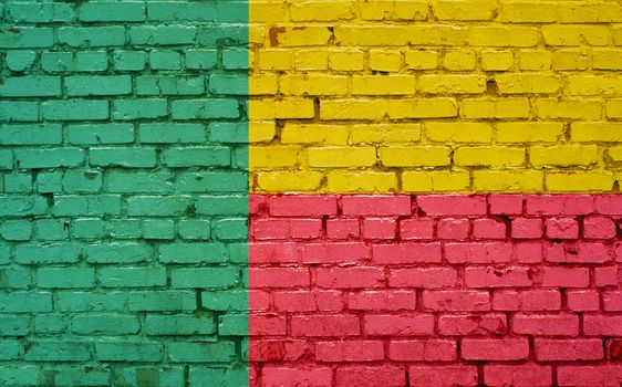 Flag of Benin painted on brick wall, background texture