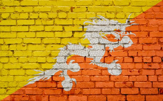 Flag of Bhutan painted on brick wall, background texture