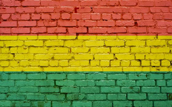 Flag of Bolivia painted on brick wall, background texture