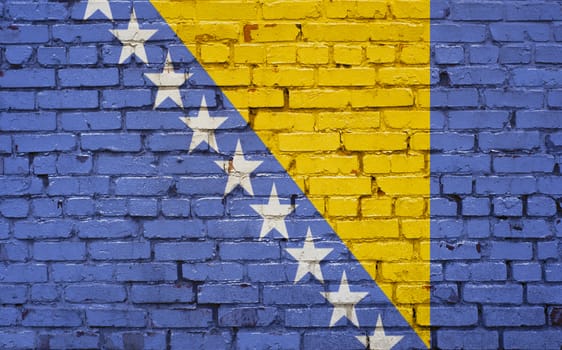 Flag of Bosnia painted on brick wall, background texture