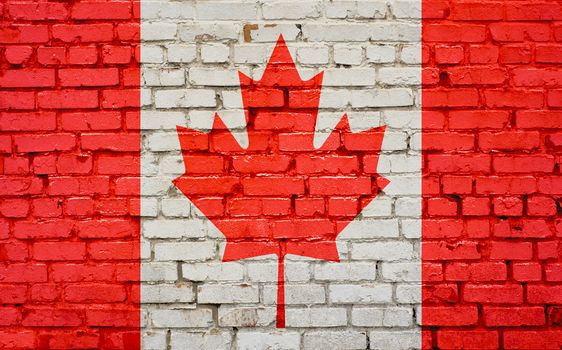 Flag of Canada painted on brick wall, background texture