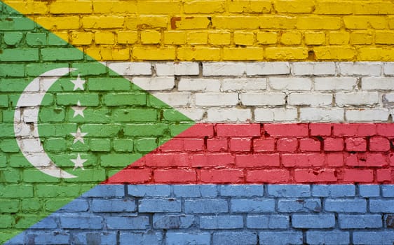 Flag of Comoros painted on brick wall, background texture