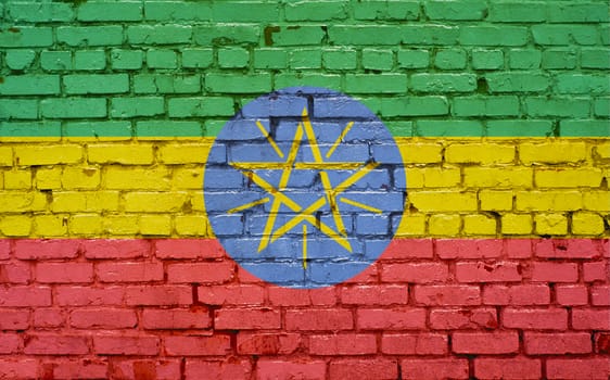 Flag of Ethiopia painted on brick wall, background texture