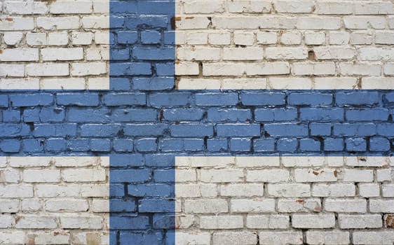 Flag of Finland painted on brick wall, background texture