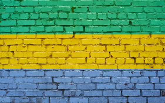 Flag of Gabon painted on brick wall, background texture