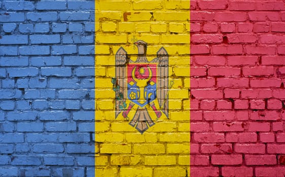 Flag of Moldova painted on brick wall, background texture