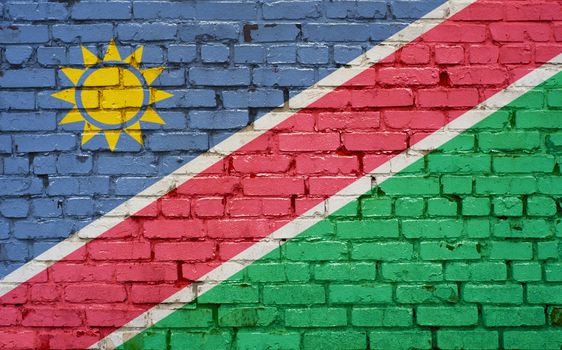 Flag of Namibia painted on brick wall, background texture