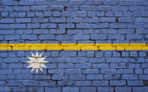 Flag of Nauru painted on brick wall, background texture