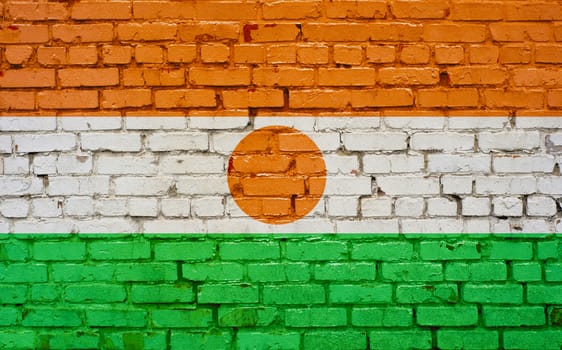 Flag of Niger painted on brick wall, background texture