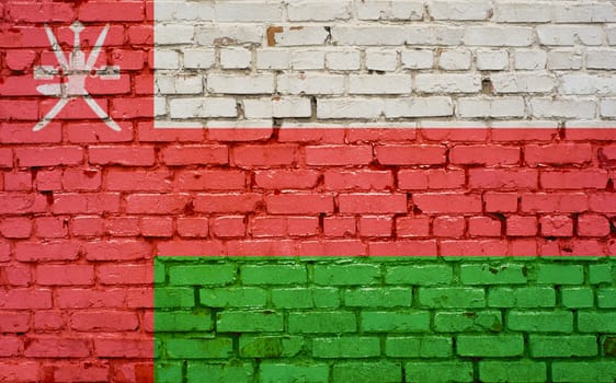 Flag of Oman painted on brick wall, background texture