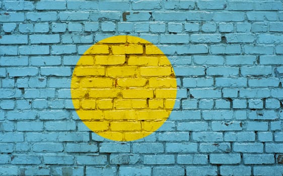 Flag of Palau painted on brick wall, background texture