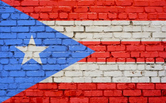 Flag of Puerto Rico painted on brick wall, background texture