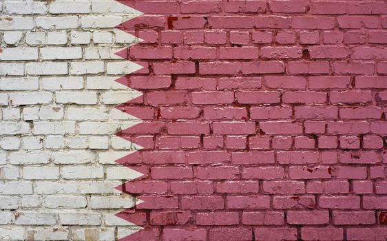 Flag of Qatar painted on brick wall, background texture