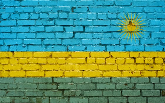 Flag of Rwanda painted on brick wall, background texture