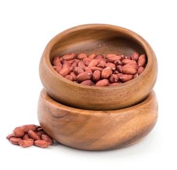 Peanuts in a bowl on a white background.