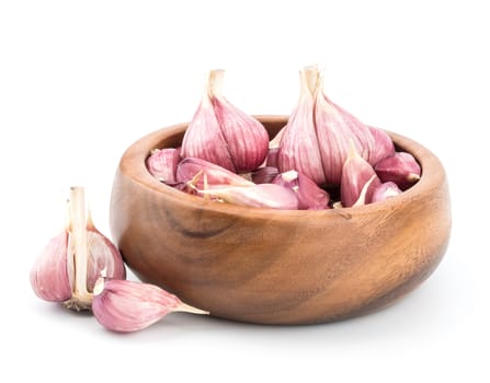 Garlic on wooden bowl of white background