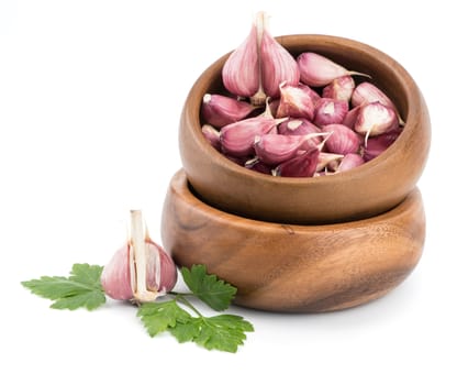 Garlic on wooden bowl of white background