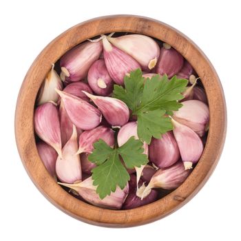 Garlic on wooden bowl top view of white background