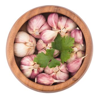 Garlic on wooden bowl top view of white background